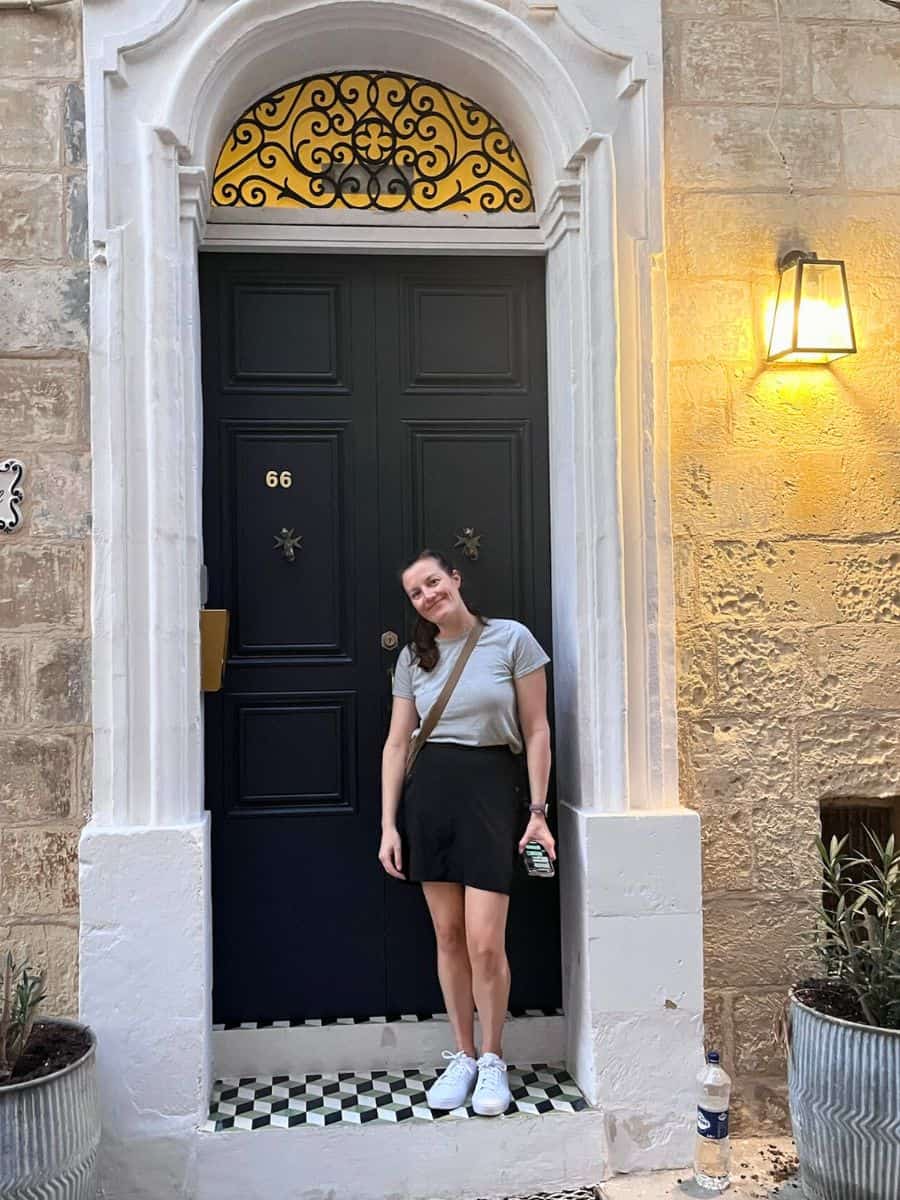 Me (Liz) of Malta Unpacked standing in front of our Senglea apartment