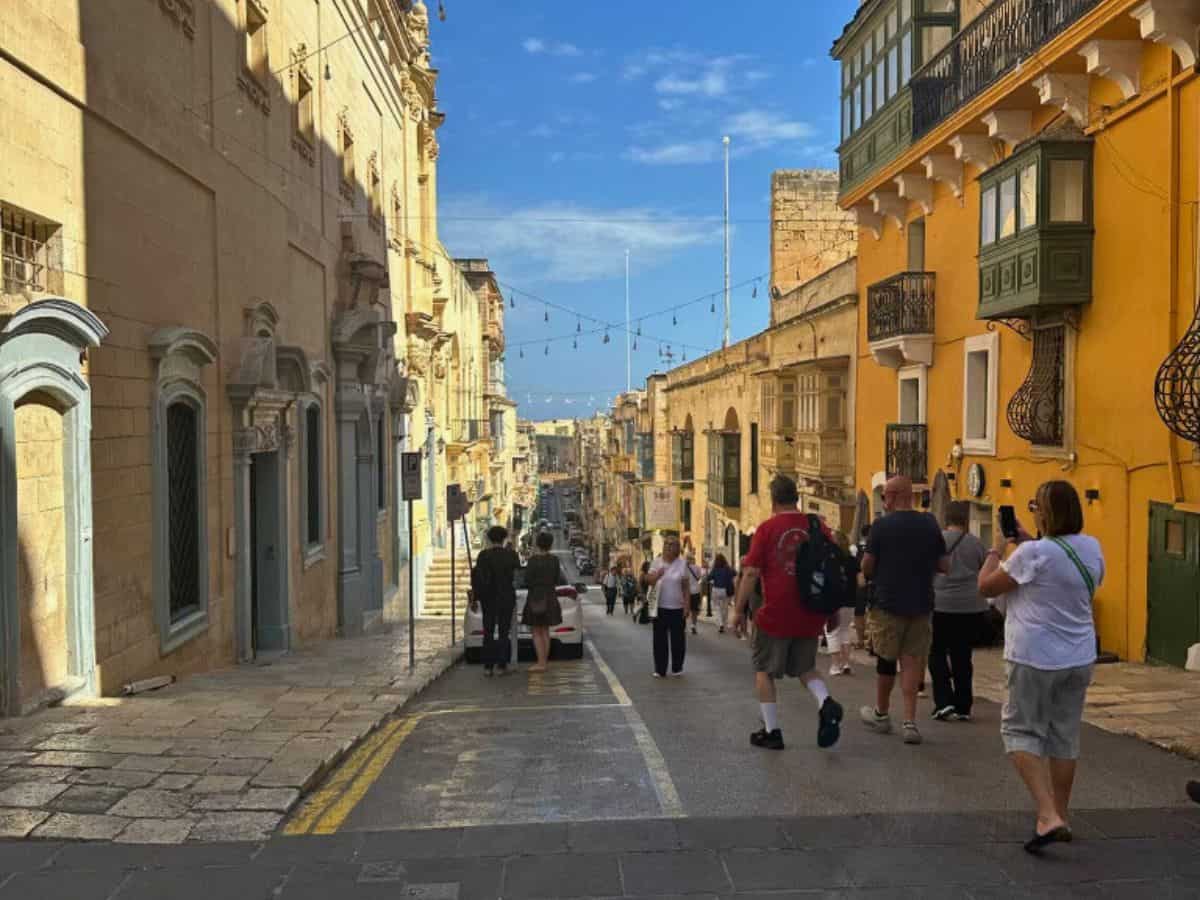 Travelers walking the streets of Valletta, Malta